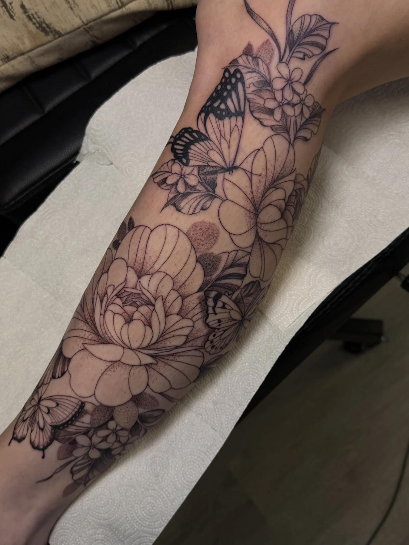 Floral and butterfly tattoo